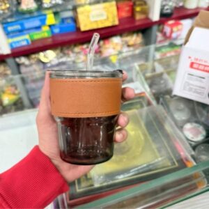 Urban Glass Sipper: Amber-Tinted Glass Tumbler with Leather-Style Sleeve & Glass Straw